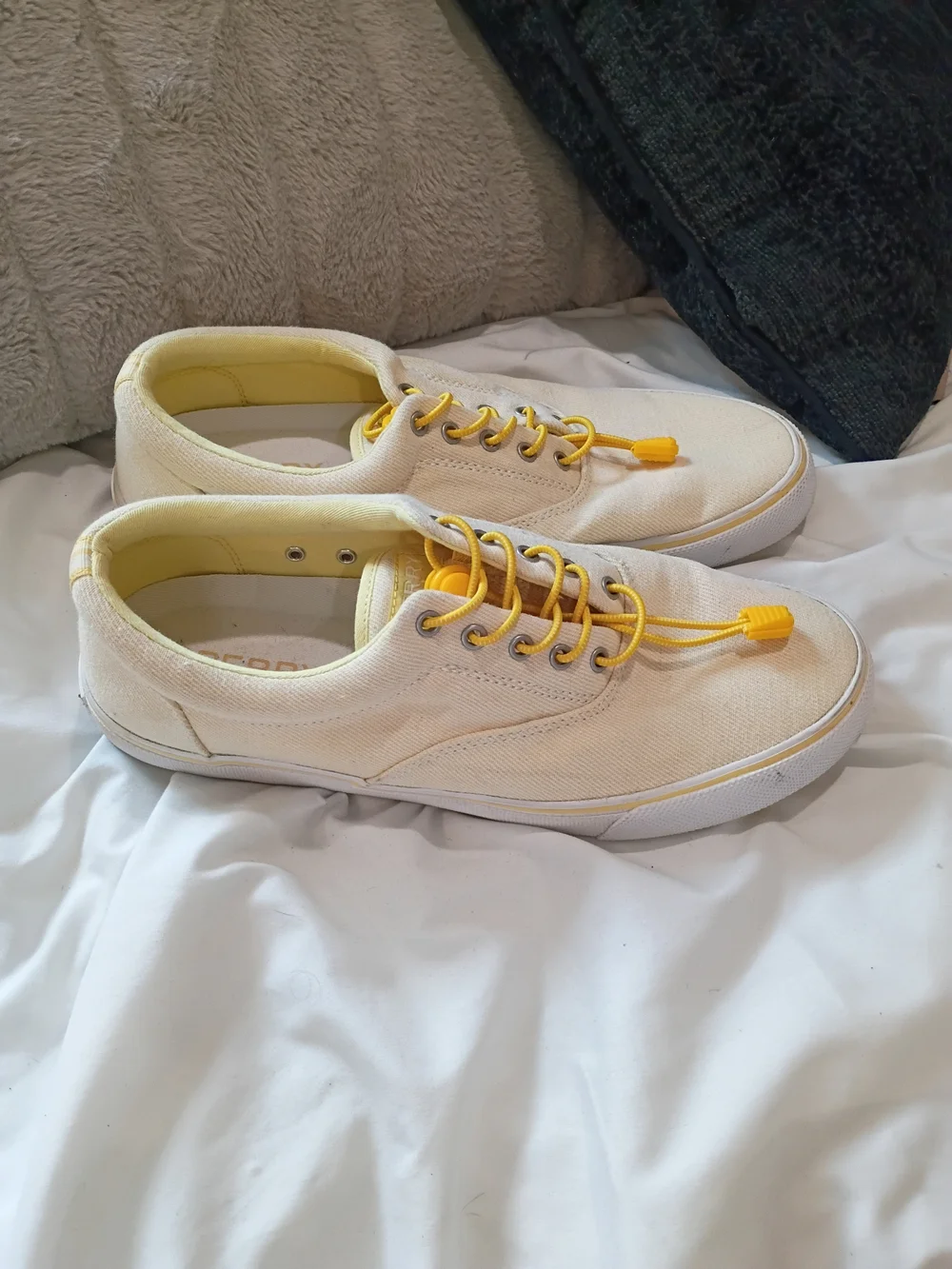 Yellow-tinged cream canvas sneakers are the Sperry Striper II CVO low-tops Sz 10